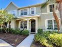 Inviting townhome with lush landscaping, neutral exterior, and charming front door at 8796 Christie Dr, Largo, FL 33771