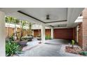 Charming courtyard with brick accents, lush tropical plants, and architectural columns at 919 Seddon Cove Way # 919, Tampa, FL 33602