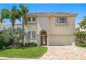 Elegant two-story home featuring a manicured lawn and classic architectural details at 927 Anchorage Rd, Tampa, FL 33602