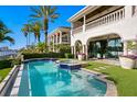 Stunning waterfront pool with lush landscaping and spacious patio area at 927 Anchorage Rd, Tampa, FL 33602
