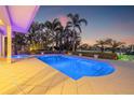 Beautiful pool area with lush tropical landscaping offering privacy and a resort-like experience at 935 Eden Isle Ne Dr, St Petersburg, FL 33704