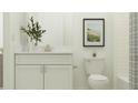 Well-lit bathroom with white subway tile, modern fixtures, and stylish decor for a fresh look at 9396 Minnow Ray Dr, Land O Lakes, FL 34638