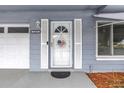 Close-up of the home's front door with decorative shutters, an American-themed wreath and house number at 11315 86Th Ave, Seminole, FL 33772