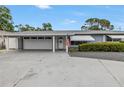 Beautiful single-story home with a spacious driveway and a welcoming entrance with an American flag at 11315 86Th Ave, Seminole, FL 33772