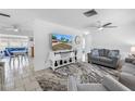 Bright and airy living room featuring neutral tones, modern furnishings, and seamless flow to the dining area at 11315 86Th Ave, Seminole, FL 33772