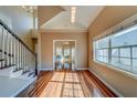 Bright foyer featuring hardwood floors, a staircase, and an adjacent dining room with large windows at 11386 Churchhill Trl, Seminole, FL 33772