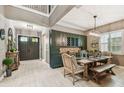Elegant dining room with stylish dark green cabinetry, modern lighting, and entry door at 12707 Green Heron Way, Odessa, FL 33556