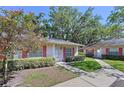 Beautiful property showcasing meticulous landscaping and walkway to entrance at 1535 Nursery Rd # 107, Clearwater, FL 33756