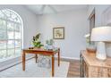Home office featuring a wooden desk, hardwood floors, and an arched window at 16501 Sandhill Crane Dr, Spring Hill, FL 34610