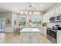 Bright kitchen featuring an island, pendant lighting, stainless steel appliances, and an adjacent dining area at 17712 Long Ridge Rd, Tampa, FL 33647