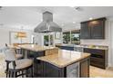 Gourmet kitchen features granite countertops, stainless steel appliances, and a center island with seating at 2057 Kansas Ne Ave, St Petersburg, FL 33703
