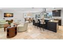 Open-concept kitchen features a large island, stainless steel appliances, and access to the living area at 2057 Kansas Ne Ave, St Petersburg, FL 33703