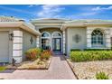 Inviting front entrance featuring a brick walkway and decorative plants, providing excellent curb appeal at 2875 Grazeland Dr, Sarasota, FL 34240