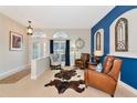 Comfortable living room with tile flooring, neutral walls and ample natural light at 2875 Grazeland Dr, Sarasota, FL 34240