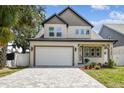 Beautiful two-story home with a paver driveway and a two-car garage at 3106 W Cherokee Ave, Tampa, FL 33611