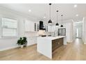 Modern kitchen with white cabinets, stainless steel appliances, and a large center island at 3106 W Cherokee Ave, Tampa, FL 33611