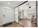 Bright bedroom with a sliding mirror door, closet, and modern ceiling fan at 511 Glenoak N St, St Petersburg, FL 33703