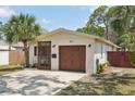 Single-story home with a well-maintained lawn and a one-car garage at 511 Glenoak N St, St Petersburg, FL 33703