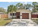 Charming single-story home with a well-maintained lawn and a one-car garage at 511 Glenoak N St, St Petersburg, FL 33703