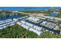 Aerial view of a waterfront townhome community with boat docks and easy access to the water at 5912 Anchorage S Way, St Petersburg, FL 33712