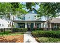 Beautiful two-story home featuring a manicured lawn, black metal fence, and inviting front porch at 6015 Shell Ridge Dr, Lithia, FL 33547