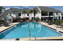 Inviting community pool with ample seating and lush landscaping at 631 Haven Pl, Tarpon Springs, FL 34689