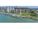 Waterfront condominium complex featuring boat slips and a beautiful outdoor pool at 650 Island Way # 204, Clearwater Beach, FL 33767