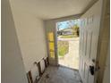 View of the entryway showing the front door and yellow-tinted glass at 6706 Del Prado Ter, New Port Richey, FL 34652