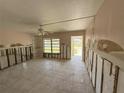 View of the living room featuring tile floors and a ceiling fan at 6706 Del Prado Ter, New Port Richey, FL 34652