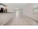Open-concept living area with tile flooring and natural light at 7205 Ronnie Gardens Ct, Tampa, FL 33619