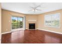Bright living room with fireplace, ceiling fan, and sliding glass doors to the outside at 9100 Dr Martin Luther King Jr N St # 314, St Petersburg, FL 33702