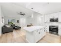 Open-concept living area with vaulted ceilings, a ceiling fan and a view into the kitchen at 1047 Deer Hollow Way, Sarasota, FL 34232