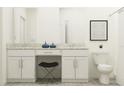 Bright bathroom with double vanity, granite countertop, vanity seating, and tiled floor at 10825 Fort White Ct, Tampa, FL 33647