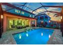 A refreshing swimming pool with sun loungers, outdoor dining, and a screened-in enclosure at 11227 Hawks Fern Dr, Riverview, FL 33569