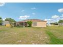Spacious backyard with lush lawn and screened lanai is perfect for outdoor entertaining and relaxation at 12124 Colonial Estates Ln, Riverview, FL 33579