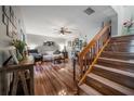Cozy living room with hardwood floors, fan, staircase, and comfortable furnishings at 15344 E Pond Woods Dr, Tampa, FL 33618