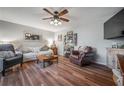 Comfortable living room features hardwood floors, soft seating, and a stylish wine rack at 15344 E Pond Woods Dr, Tampa, FL 33618