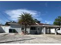 Charming single story home features a carport, palm tree, and an inviting front porch at 2117 W Clifton St, Tampa, FL 33603