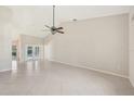 Open living room boasts tile flooring, neutral walls, and lots of natural light at 26180 Deep Creek Blvd, Punta Gorda, FL 33983