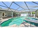 Screened-in in-ground pool and hot tub with attached, covered patio at 26180 Deep Creek Blvd, Punta Gorda, FL 33983