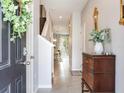 Foyer showcasing hardwood floors, an entry table, and view to dining area and backyard at 2882 Suncoast Plains Dr, Odessa, FL 33556