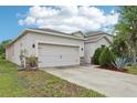 Spacious two-car garage with a long driveway and an attractive exterior at 304 Shell Manor Dr, Ruskin, FL 33570