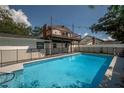 Fenced backyard pool with a wooden balcony, ideal for summer enjoyment at 3212 W Arch St, Tampa, FL 33607