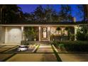 Inviting single-story home with a charming entrance, a decorative fountain, and manicured landscaping at 3505 W Kensington Ave, Tampa, FL 33629