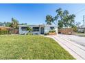 Attractive single-story house with a lush green lawn, concrete driveway, and a well-maintained exterior at 4001 W North A St, Tampa, FL 33609