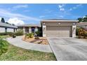 Charming single story home boasts a two-car garage, inviting walkway and mature landscaping at 4017 3Rd E Ave, Bradenton, FL 34208