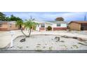 Well-maintained single-story home with a tidy rock garden and a circular driveway, offering convenient access at 4031 Chesswood Dr, Holiday, FL 34691