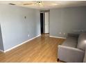 Neutral living area showcasing hardwood floors, soft gray walls, and a comfortable, modern sofa at 4031 Chesswood Dr, Holiday, FL 34691