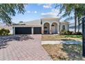 Charming home featuring a spacious three car garage and a brick paved driveway at 4809 Walnut Ridge Rd, Land O Lakes, FL 34638