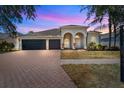 Charming home featuring a spacious three car garage and a brick paved driveway at 4809 Walnut Ridge Rd, Land O Lakes, FL 34638